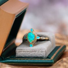 Introducing the Blue Fire Opal Engagement Ring, a masterpiece of elegance and enchantment. This stunning piece features a vibrant Blue Fire Opal, its mesmerizing play of colors capturing the essence of the ocean's depths and the brilliance of the night sky. The opal is carefully set in 14K Yellow Gold Vermeil, which offers a rich, warm glow that beautifully complements the stone's iridescent hues.►Crafted with exceptional attention to detail, this unique Fire Opal Promise Ring is designed to cel Fairy Core Aesthetic, Fire Opal Engagement Ring, Opal Promise Ring, Mens Wedding Bands Black, Blue Fire Opal, Opal Engagement Ring, Black Wedding Band, Fire Opal Ring, Opal Engagement