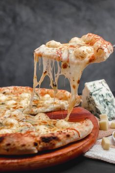 a slice of cheese pizza being lifted from a plate