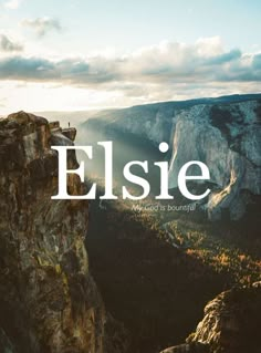 an image of the word elsie on top of a cliff with mountains in the background