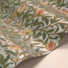 a close up view of a wallpaper with flowers and leaves on the outside of it