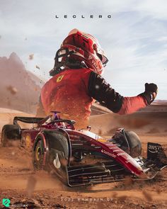 a man riding on the back of a red race car in dirt field next to mountains