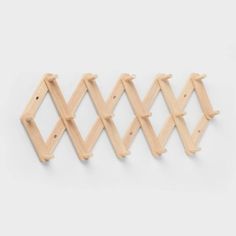 three wooden pegs are hanging on the wall