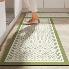 a woman is standing on the kitchen floor