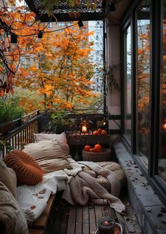 a cozy balcony with fall foliage and candles