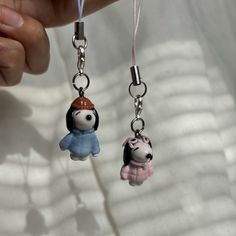 two key chains with small cartoon characters hanging from them