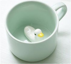 a white mug with a rubber duck in it