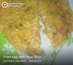 two pieces of fried egg with meat floss on a green and white flowered plate