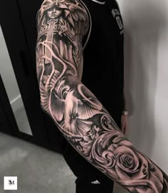 a man with a full sleeve tattoo on his arm