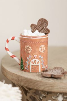 Get into the holiday spirit with our Gingerbread House Ceramic Mug. Featuring a charming gingerbread house design, this festive mug is perfect for enjoying your favorite seasonal beverages. Whether you're sipping hot cocoa, coffee, or tea, this delightful mug adds a touch of holiday cheer to your everyday routine.