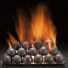 an outdoor fire pit with rocks and flames