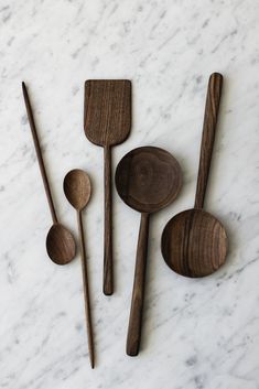 three wooden spoons, one with an oval handle and the other with four smaller spoons