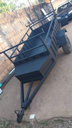 a blue trailer sitting on top of a dirt road