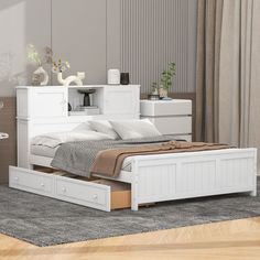 a white bed with two drawers underneath it