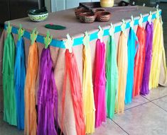 the table is decorated with colorful streamers and tassels on it's edges