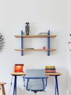 a chair and desk with shelves on the wall