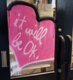 a pink heart painted on the side of a door that says it will be ok