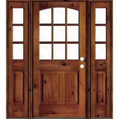 a wooden door with two sidelights and glass panels on the top part of it