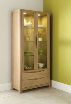 a wooden cabinet with glass doors in a room