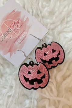 pink glitter jack - o'- lantern earrings with black outline on white furnishing