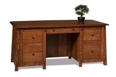 a wooden desk with drawers and a potted plant on top