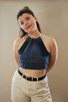 "The \"Hatty halter\" is a crop top handmade from pre-loved denim. Featuring  a rope tie around the neck giving a ruched look with a tie around the body. This is the perfect day top for the beach, BBQ, Picnic or even by the pool. The options are endless. Match with our Bamboo towelling shorts or skirt.  Style out with either sandals, sliders or pumps to look uber cool.  What a great addition to your summer wardrobe.  Top sizing and details: one size, model is a size 12-14 dress size (uk) Bust/chest - fit between A-C cup top length - 12.5\"  32cm  Rope fastening.  Fabric is 40% bamboo 40% cotton and 20% poly  About us: Reclaimed Roundabout is run by a mother and daughter team who design and make everything in Brighton, England.  We are dedicated to handmade sustainable fashion with a touch Fitted Denim Halter Neck Top, Denim Cropped Crop Top For Summer, Stretch Denim Cropped Crop Top, Fitted Cropped Halter Top With Tie Back, Fitted Denim Halter Top For Spring, Stretch Cropped Denim Top For Summer, Festival Fitted Crop Top With Tie Back, Festival Cropped Fitted Halter Top, Dark Wash Cropped Summer Crop Top