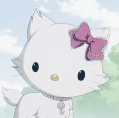 a white kitty with a pink bow on it's head standing in front of trees