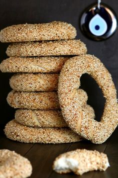 a stack of bagels sitting on top of a wooden table