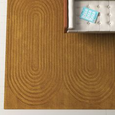 an overhead view of a living room with a couch and coffee table on the floor