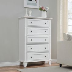 a white chest of drawers in a living room