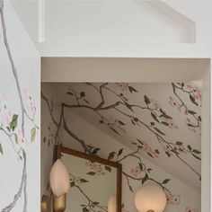 a bathroom with floral wallpaper and mirrors