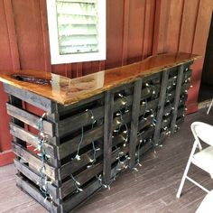 a bar made out of pallets with lights on it