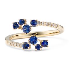 two yellow gold rings with blue sapphires and diamonds