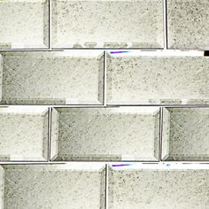 a close up view of a wall made out of white bricks with gray speckles