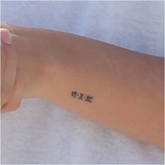 a person's arm with the word wxp tattooed in black ink on it