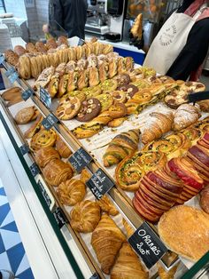 an assortment of baked goods on display at a bakery