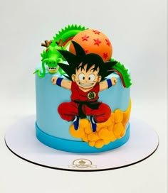 a birthday cake decorated with an image of gohan and his dragon ball toys on top