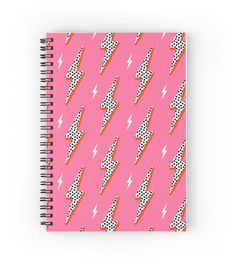 a spiral notebook with pink background and lightning bolt pattern on the front, featuring polka dots