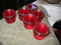 six red glasses sitting on top of a towel