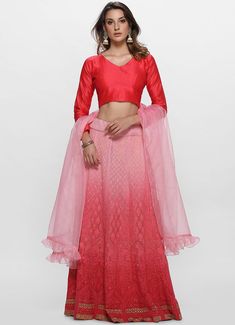 This opulent looking all over Lucknawi thread and zari chikankari embroidered kalidaar lehenga set is a must have this season. It is paired with a coral pink dupion crop top with deep V neck and full sleeves. The pink ombre effect on the skirt makes this outfit all the more spectacular. A matching organza dupatta with frill detailing is added to complete the look. Chikankari Lehenga, Organza Dupatta, Ombre Effect, Pink Ombre, Full Sleeves