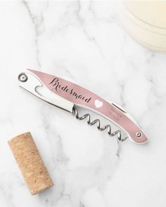 a bottle opener with a corkscrew attached to it on a marble counter top