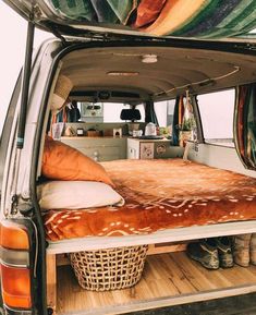 the back end of a van with a bed in it