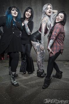 three women with tattoos and piercings posing for the camera