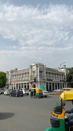 an old building in the middle of a busy street