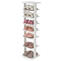 a white shelving unit with several pairs of slippers