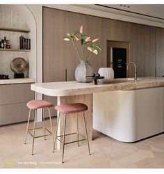 a kitchen with marble counter tops and stools