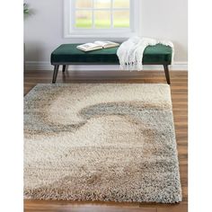 a white rug with a green bench in front of it and a window behind it