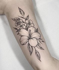 a black and white flower tattoo on the arm