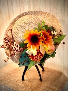 a hat with flowers is sitting on top of a table