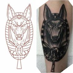 an egyptian tattoo design with the head of an animal in black and grey ink on a man's arm