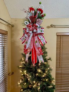 a christmas tree decorated with candy canes and bows